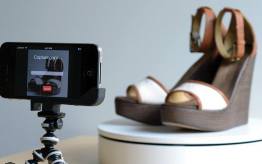 An image showing a camera capturing a pair of shoes for a product video, taken by SmartCuts Creative, based in Bussigny.
