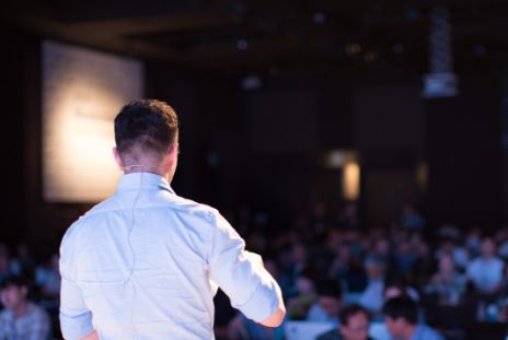 man presenting image presenting on camera