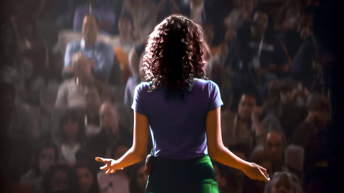 Image showing a woman speaking to a crowd to illustrate the media training and public speaking service offered by SmartCuts creative agency studio in Lausanne and Geneva, Switzerland for the purposes of creative communication.
